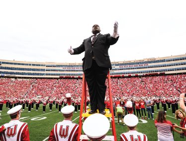 Corey Pompey conducts the UW Marching Band during a Badger football game