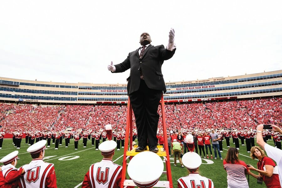 Corey Pompey conducts the UW Marching Band during a Badger football game