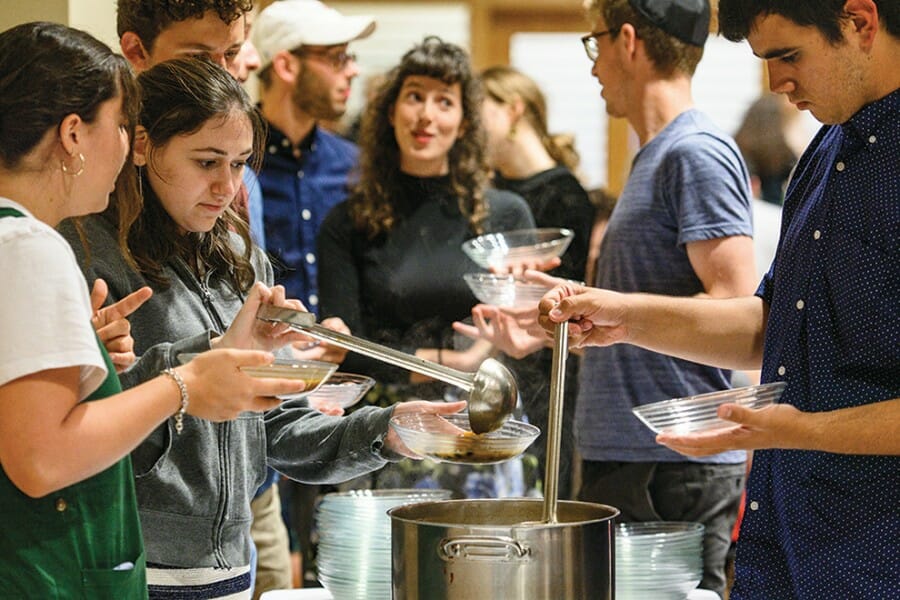 Students serve themselves food at a Hillel Shabbat dinner