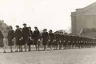 Uniformed members of of WAVES march at Camp Randall Stadium during a football game