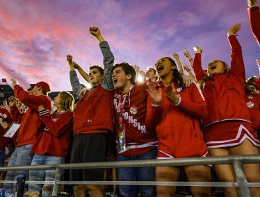 As the sun sets over the stadium, badger fans cheer on the team during the Rose Bowl Game in Pasadena, California on Jan. 1, 2020.