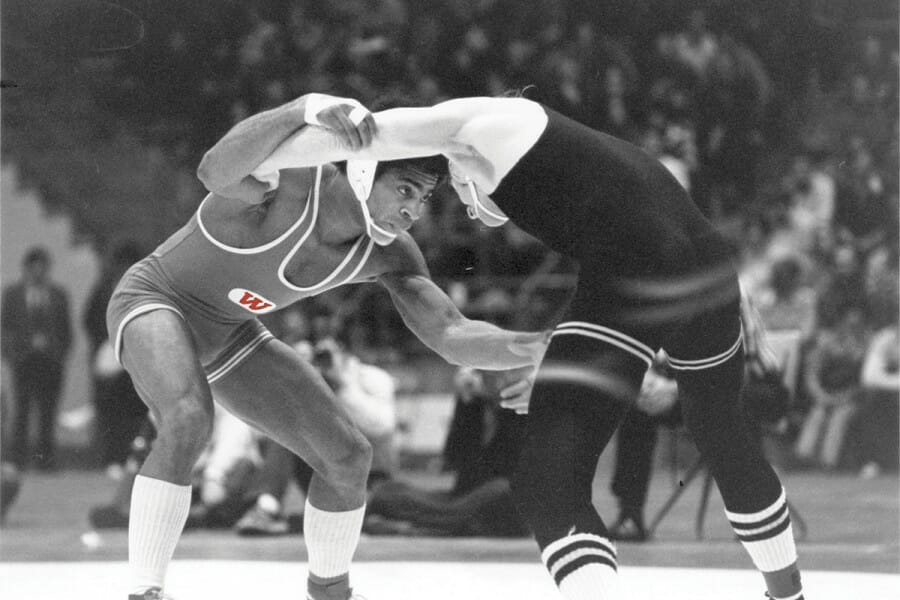 Kemp, above left, wrestled University of Iowa NCAA champion Chuck Yagla in the 1976 East-West Allstar meet, winning 10–4. Just several months earlier, the UW sophomore had beaten Olympic gold medalist Dan Gable at the Field House.