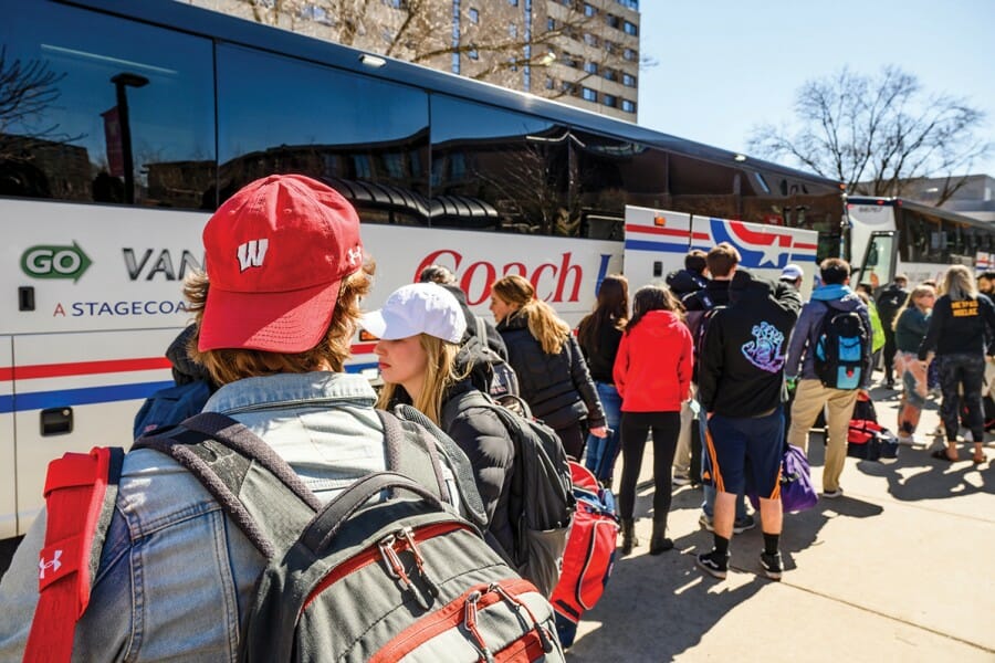 Students board buses to leave campus on March 13.