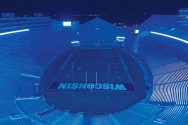 Empty Camp Randall stadium illuminated in blue light