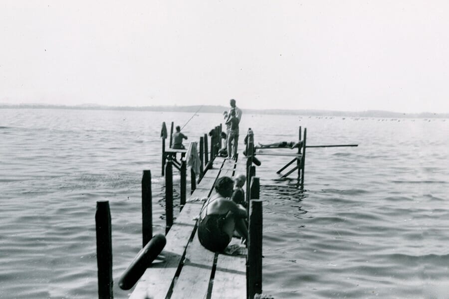 Residents of Camp Gallistella relax on a Lake Mendota pier
