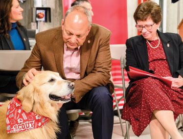 WeatherTech founder and CEO David MacNeil with his dog Scout and UW chancellor Rebecca Blank