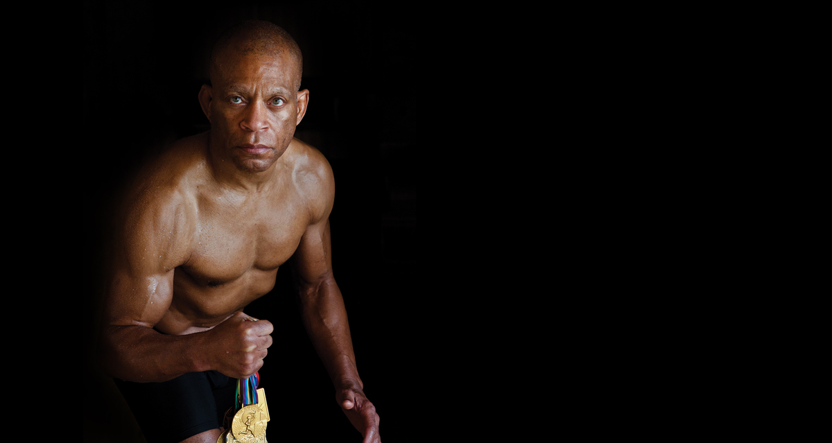 Lee Kemp holding medals