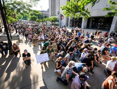 Protesters kneel near Memorial Library