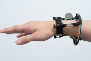 A person's hand modeling a 3-D tracking wristband