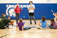 Physical Education teacher and student teacher instruct a grade school class