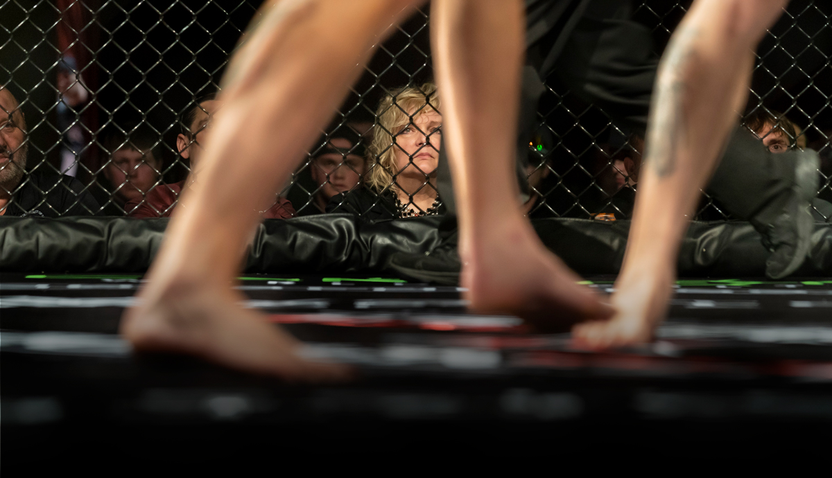 Mary Edwards watches a martial arts match from outside the ring