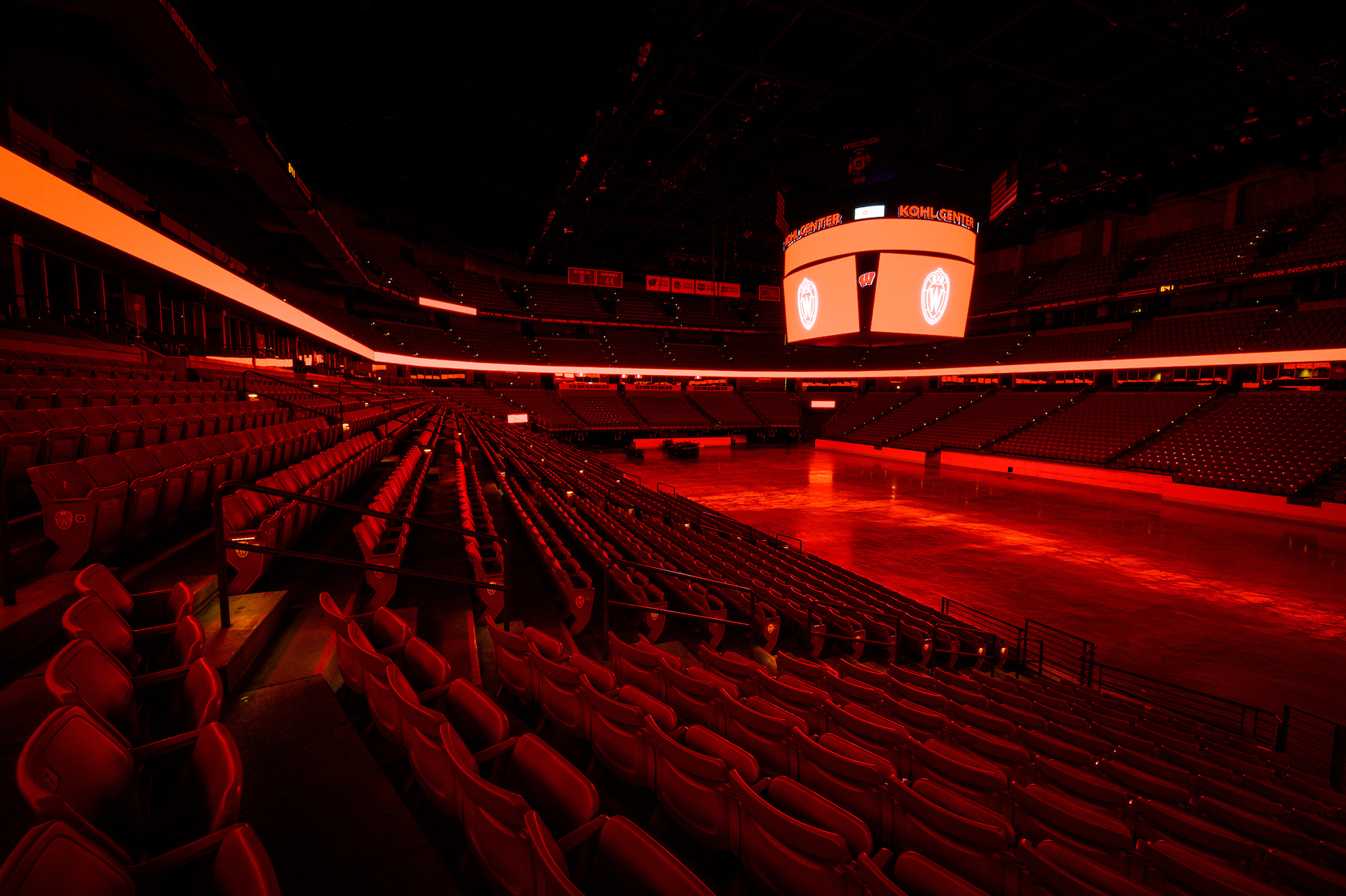 In a visual tribute honoring the graduating Class of 2020, the interior arena of the Kohl Center at the University of Wisconsin-Madison glows in a bath of red light at night