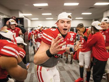 Members of the UW–Madison Badger football team react after dropping the Mayo Bowl trophy