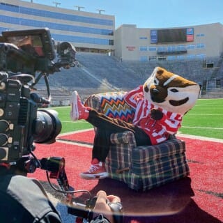 Bucky Badger poses for video camera on Camp Randall Field