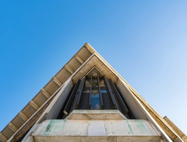 Photo of angular corner of the UW–Madison humanities building against blue sky
