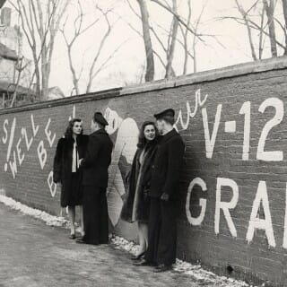 Cadets in the U.S. Navy's V-12 training program loiter by the Kiekhofer Wall in the 1940s. The wall was a social media platform for the pre-digital age.