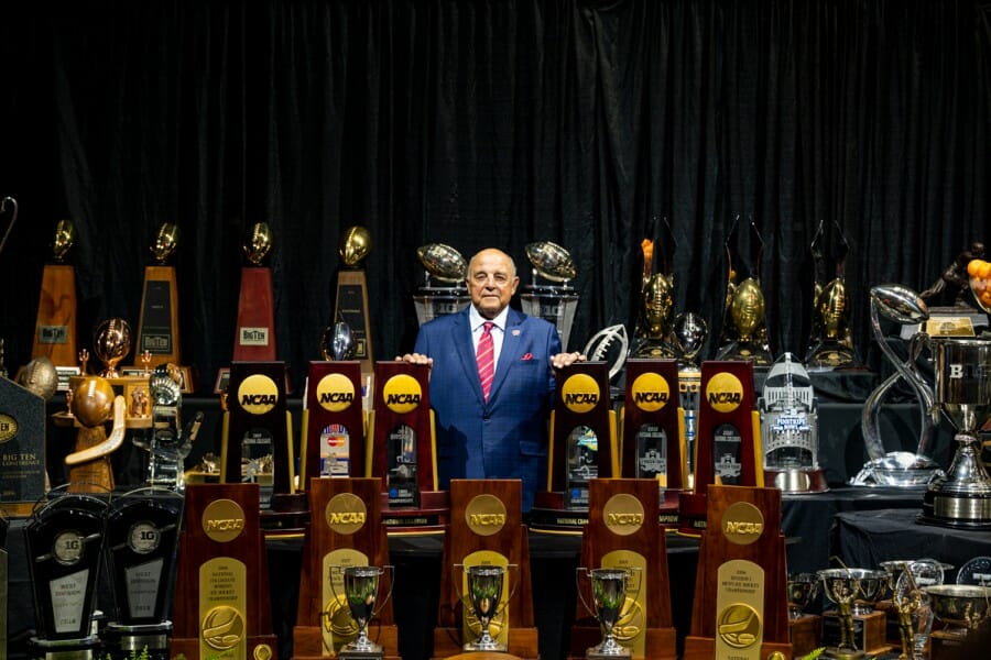 Barry Alvarez poses amidst all of the trophies won during his tenure as UW Athletics Director