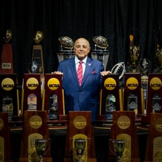 Barry Alvarez amongst all the trophies won during his tenure as UW Athletics Director
