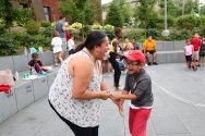 Woman and child dance at the Multicultural Summer Picnic at Alumni Park