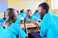 Refugee students playing board game