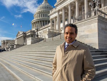 Manu Raju in front of the U.S. Capitol building