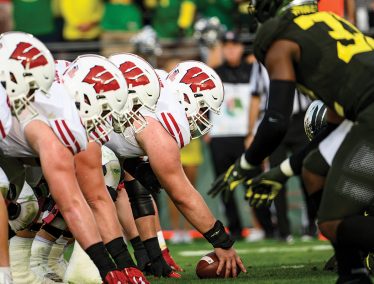Close-up photo of Badger football players on the field