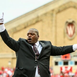 Corey Pompey directs the UW Marching band at Camp Randall