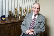 Walter Mirisch with several Academy Awards statuettes