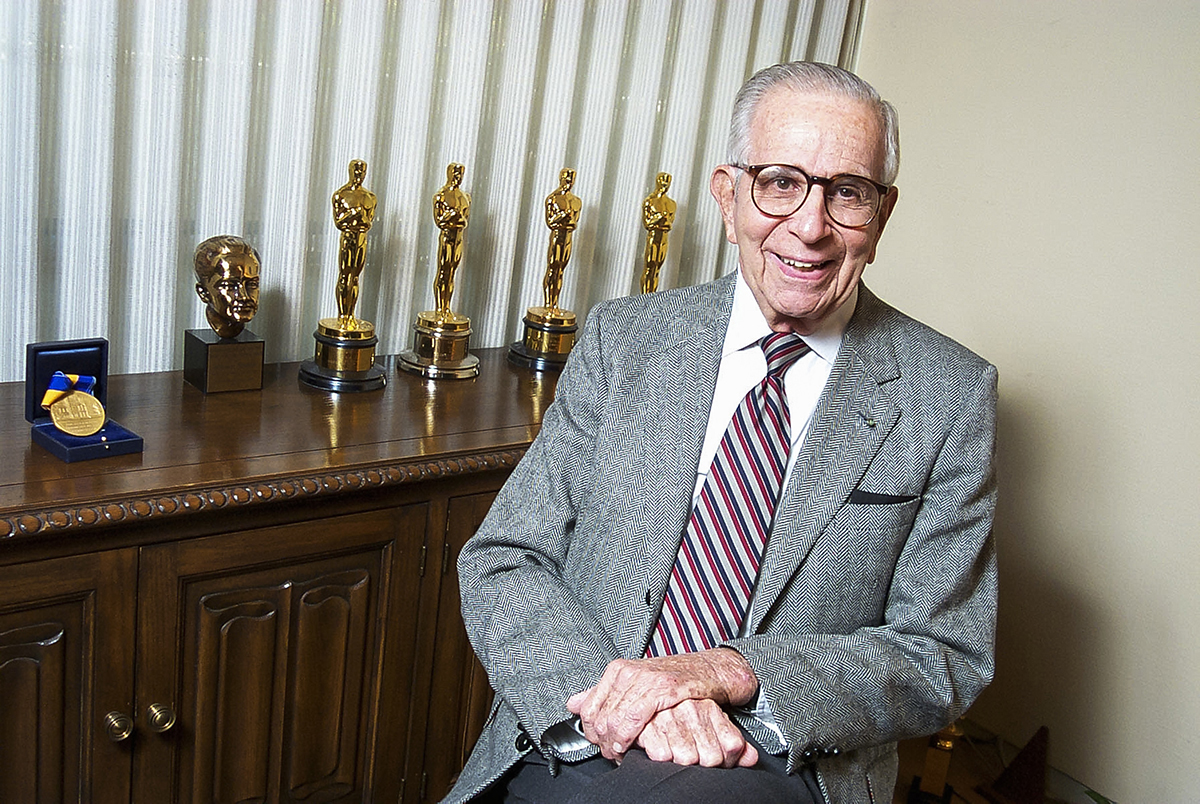 Walter Mirisch with several Academy Awards statuettes