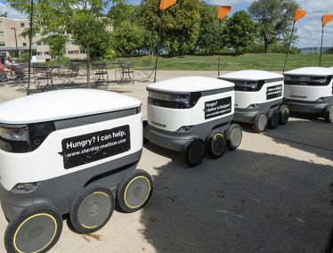 Row of UW Housing food delivery robots on Library Mall