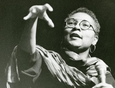 Black and white photo of bell hooks giving a lecture