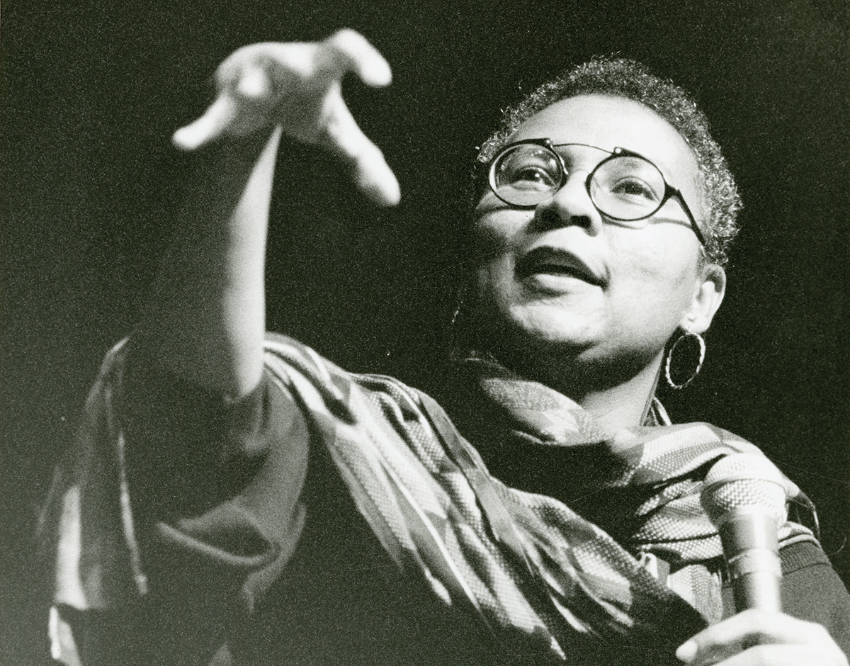 Black and white photo of bell hooks giving a lecture