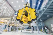 NASA technicians work on the large yellow Webb telescope