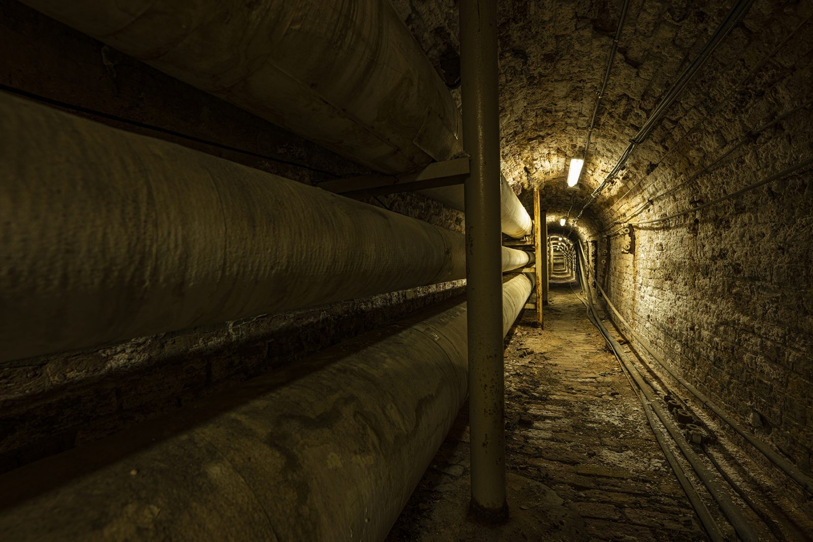 Photo of underground passageway lined with steam pipes on the UW–Madison campus