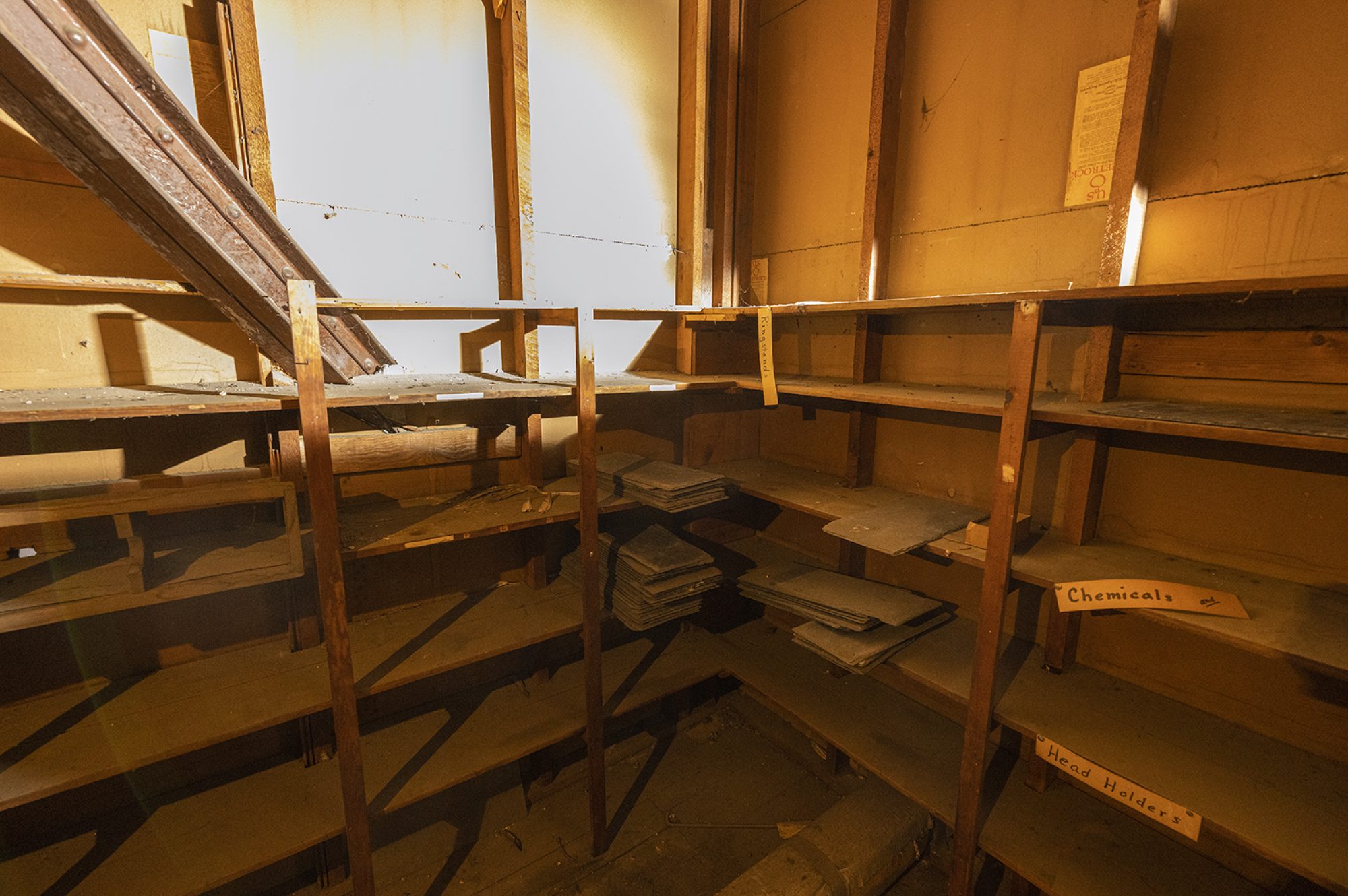 Rows of wooden shelves line a corner of the Science Hall attic