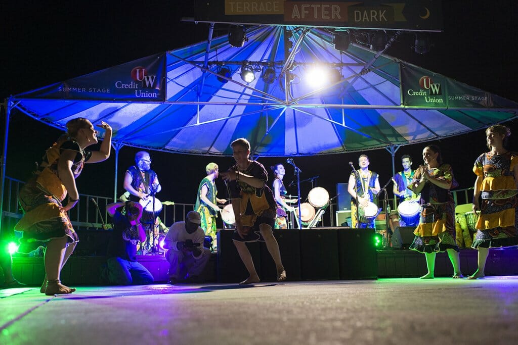 Band performs at night on the outdoor stage at the Memorial Union Terrace