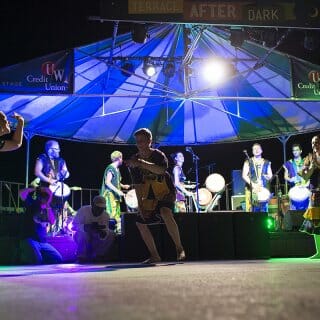 Band performs at night on the outdoor Terrace stage
