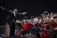 Corey Pompey, Director of Athletic Bands and Associate Director of Bands, enthusiastically leads UW Varsity Band Spring Concert dress rehearsal in the Kohl Center