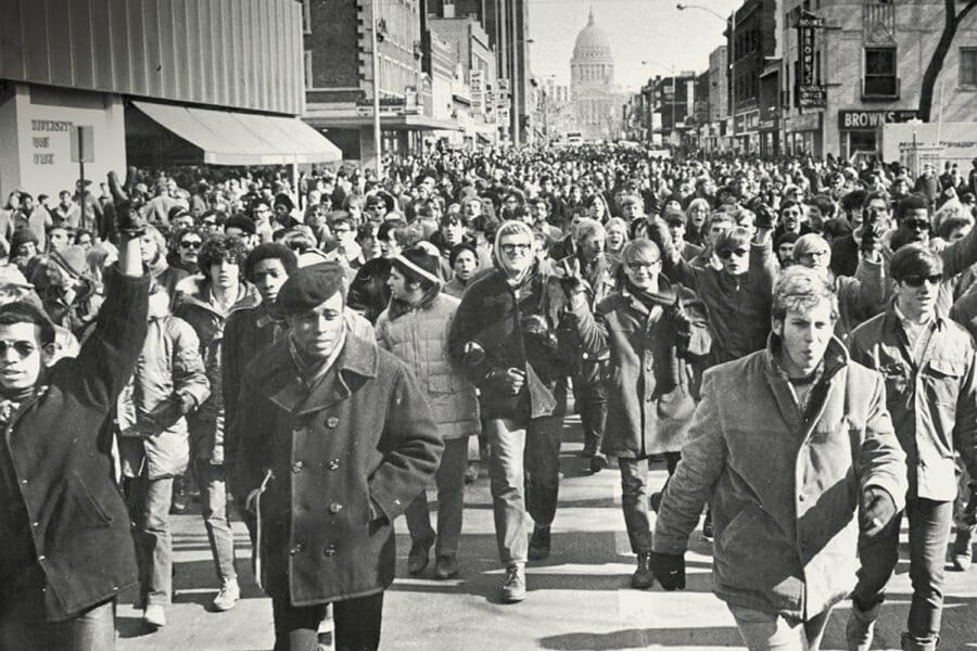 Black and white photo of the 1969 Black student strike depicting students of color and their allies marching down State Street