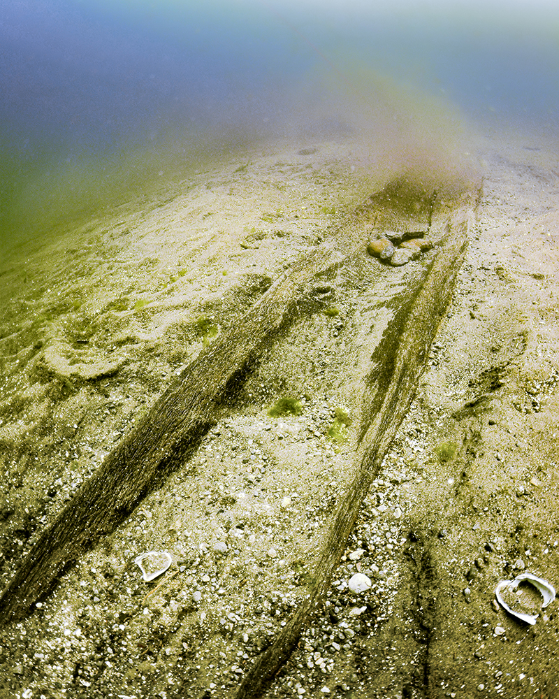 Underwater photo of canoe covered in lake sediment