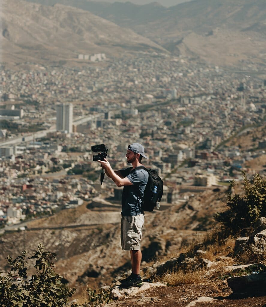 Binky photographs a mountainous urban landscape in Iraq