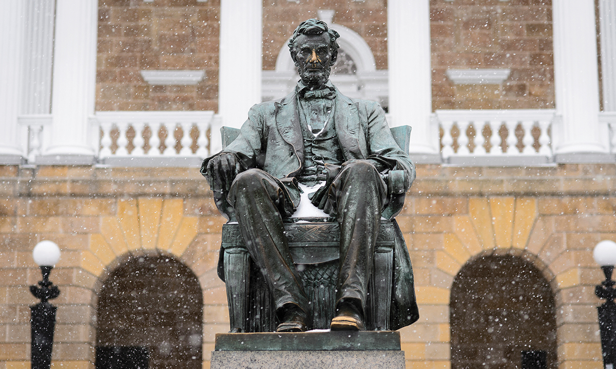 Falling snow covers the Lincoln statue on Bascom Hill