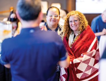 Chancellor Jennifer Mnookin wears a blanket presented to her by members of the Ho Chunk Nation