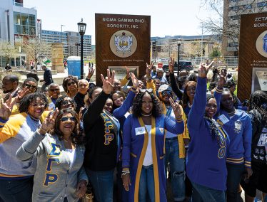 Members of the Sigma Gamma Rho Sorority celebrate and take photos with their cell phones
