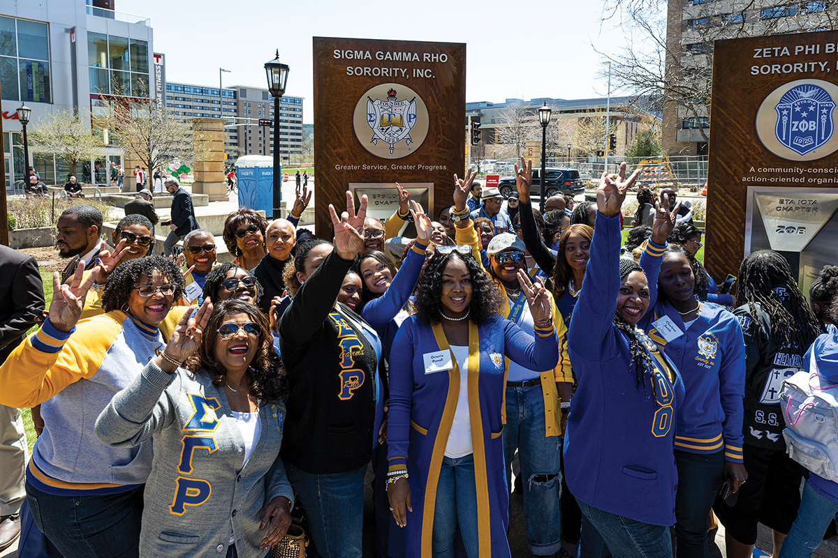 Members of the Sigma Gamma Rho Sorority celebrate and take photos with their cell phones