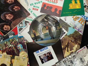 Different album covers spread out including The Beatles