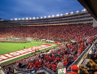 Badger fans fill Camp Randall at night as the UW Marching band performs