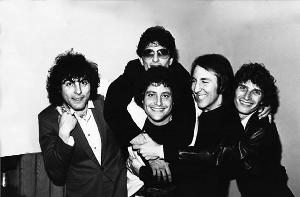 Black and white photo of Bruce Ravid with members of the band The Knack