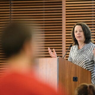 Diana Hess speaks at lecturn