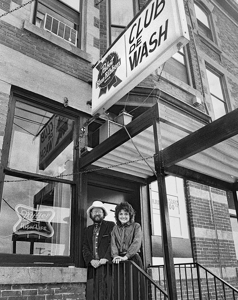 Black and white photo of Peter and Lou Berryman outside of the Club de Wash bar